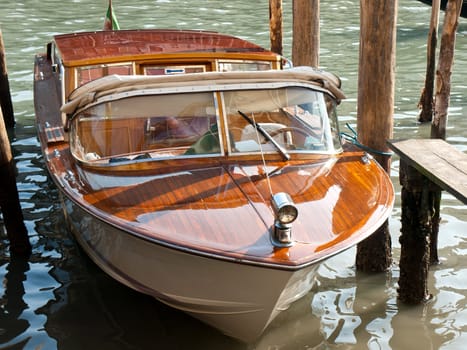 wooden riva boat parked on the canal in Venice