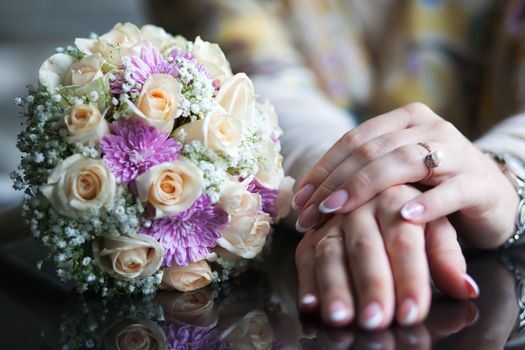 Hand with flowers on the wooden table