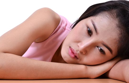 Sad beautiful woman standing against a white background