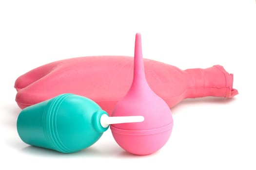 Medical hot-water bottle and colonic bulb for procedures on a white background