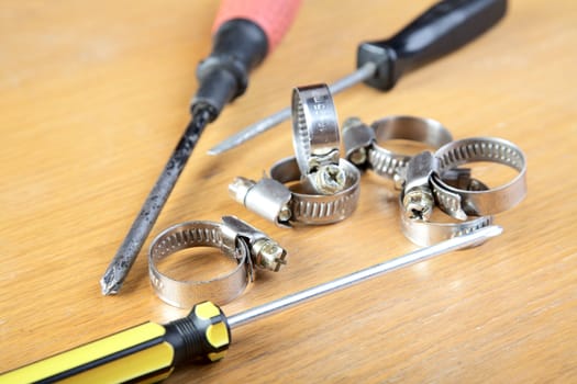 Screw-drivers and clips for hoses on a wooden table
