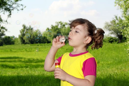 little girl blowing bubbles