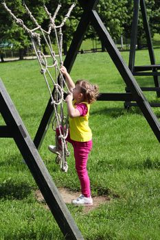 little girl playing on playground