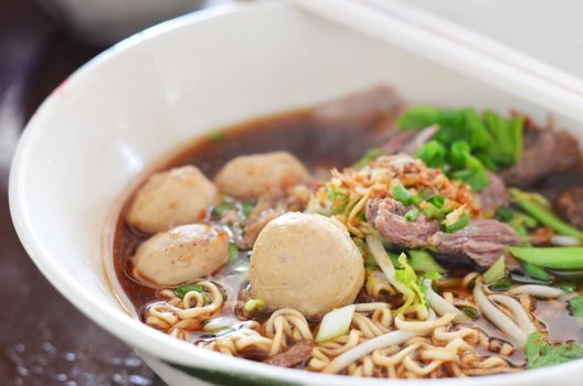 close-up of instant noodles and  meatball  with chopsticks , asian noodle