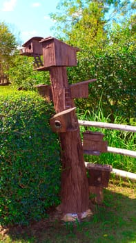 Wooden Bird house on a tree.