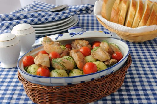 Baked potatoes with dill and chicken and tomatoes