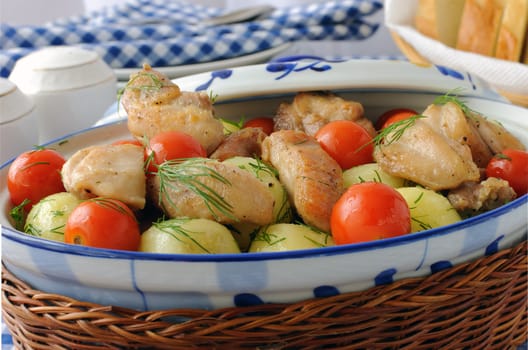 Baked potatoes with dill and chicken and tomatoes