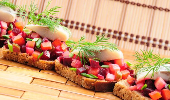 Sandwiches with rye bread, herring and vegetables