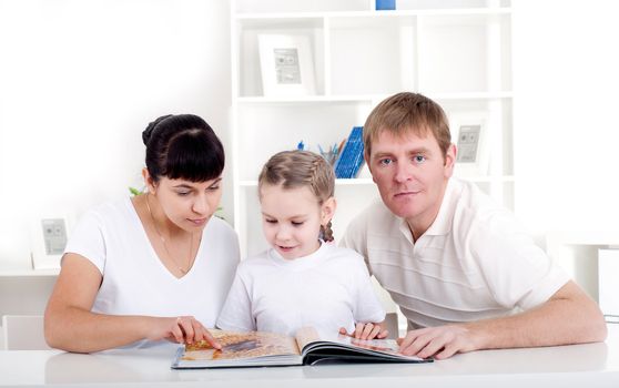 Family reading a book together, a family vacation