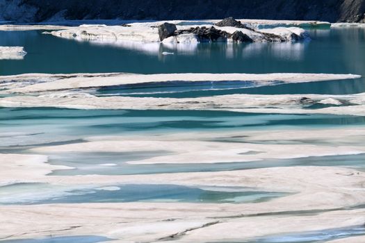 Ice floats amidst a pool of glacial meltwater below the Grinnell Glacier in northern Montana.