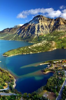 Sweeping view over blue waters and rugged mountain peaks of Waterton Lakes National Park in Canada.