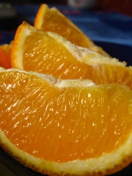 Three fractions of the cut orange on a plate