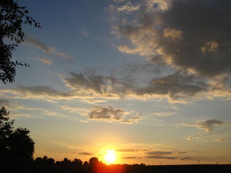 The landscape with beautiful picturesque clouds and sunset