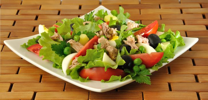 Vegetable salad with tuna, egg and olives