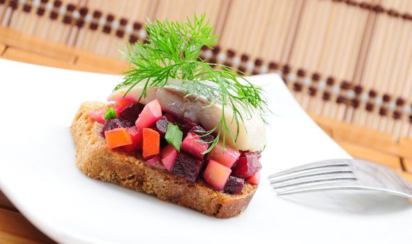 Sandwiches with rye bread, herring and vegetables