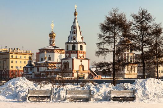 Orthodox churches, built in the early nineteenth century behind three empty benches. Siberia, Russia