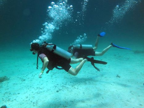 Two Scuba Divers between Water Surface
