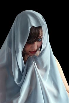 Portrait of beautiful woman praying on a black background.