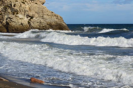 high waves breaking on the rocky coast of Malaga