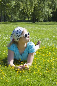 little girl lying on grass 