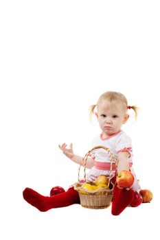 child with apples on the floor