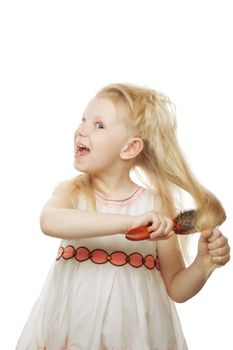 laughing small girl combing her hair