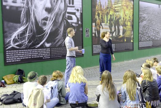 Young tourists on street photo-exhibition in Copenhagen, Denmark. Taken on May 2012