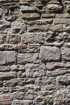 Old wall with irregular pattern of stone - background.