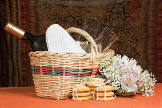 A basket with bottles and glasses Composition