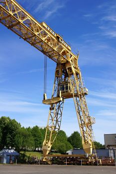 The industrial crane on a background of the blue sky