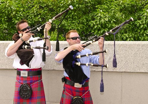 Bagpipe duo having fun  between songs as they entertain tourists in Ottawa, Canada.