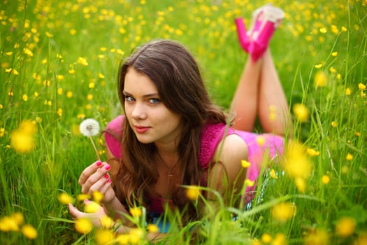 summer woman blow on dandelion 