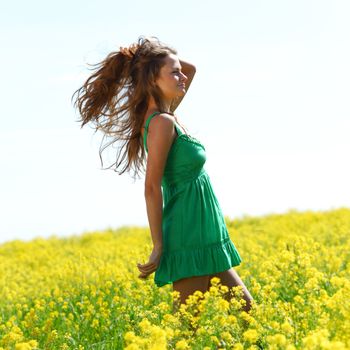 woman on oilseed field close portrait