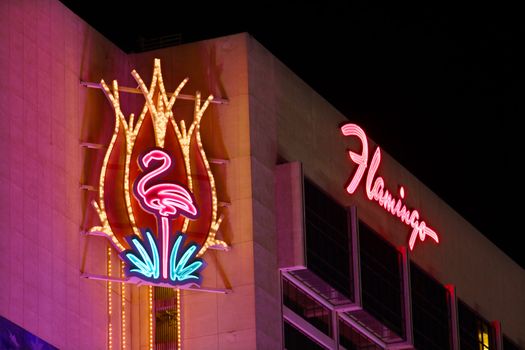 Las Vegas, USA - November 30, 2011: The Flamingo Las Vegas is a hotel and casino located on the famous Las Vegas Strip and has a art deco theme.  Seen here is the top portion of the hotel building with decorative neon signs.