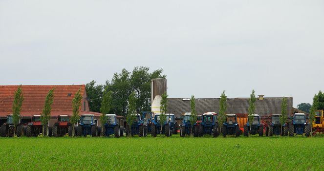 Row of agriculture tractor machines