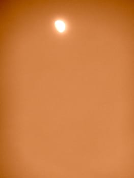 orange sky with the moon as a background