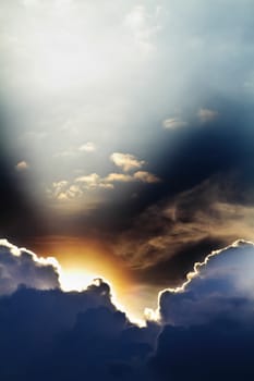 View of clouds in blue sky with rays of light