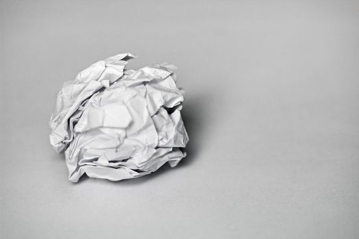 A ball of white paper on a gray background