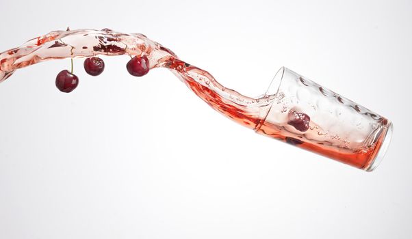 fresh red ripe cherry juice splash with glass