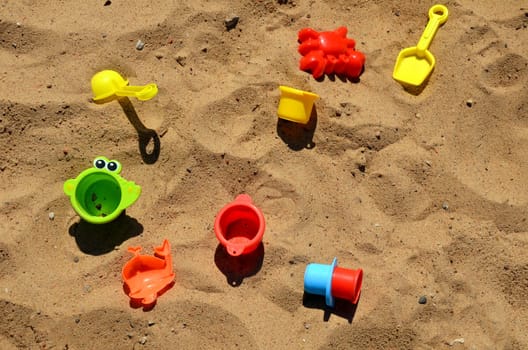 Various children's toys on the sand