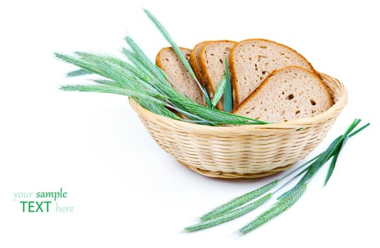 tasty baked bread with ears of wheat, isolated on a white background