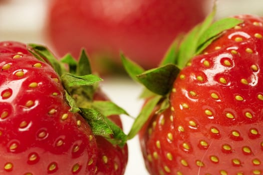 Two appetizing brightly red and juicy strawberries