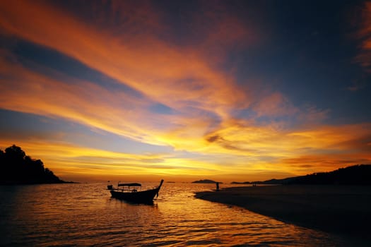 a sunset sky from tropical island with boat