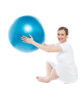 Beautiful pregnant woman sitting with exercise ball isolated on white background