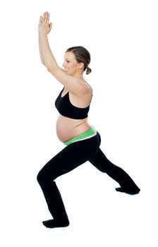 Healthy pregnant woman doing gymnastics over white background