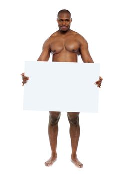 Naked black man hiding behind blank white billboard. Copyspace