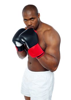 Shirtless african boxer aiming to punch you. Be alert.