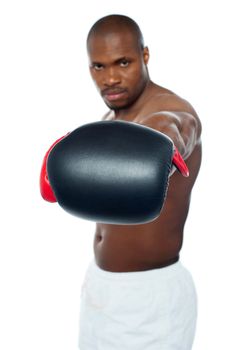 Muscular black boxer punching right into camera. Feel the heat.