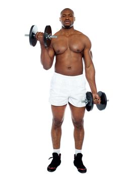 Muscular man exercising with dumbbells isolated against white background