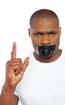 Tape on mouth of an african male model pointing upwards.